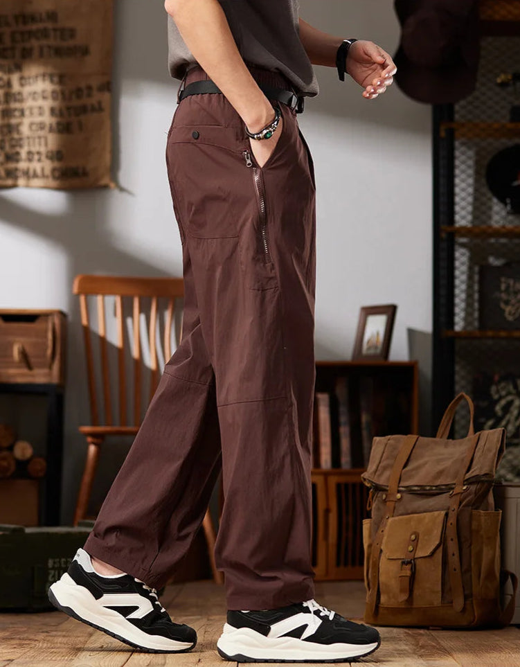 Person wearing brown workwear casual pants with a rustic interior setting.