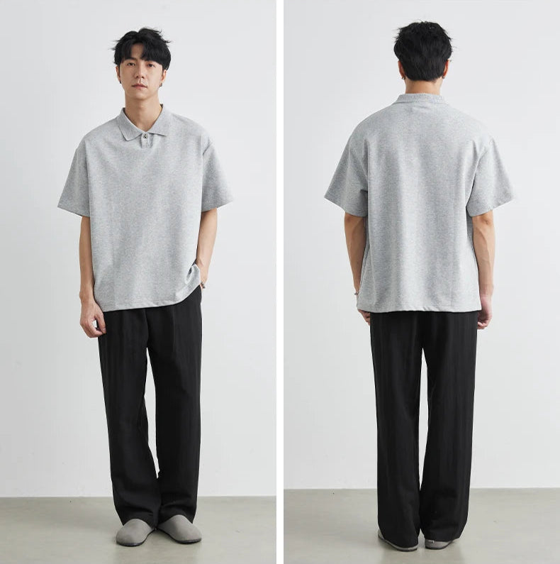 Person wearing a gray polo shirt and black pants, shown from front and back views.