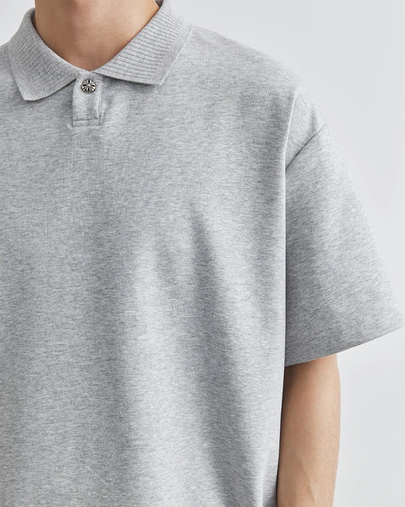 Gray polo shirt worn by a person on a white background