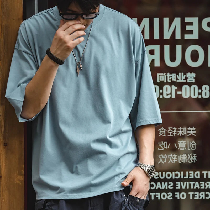 Person wearing a light blue shirt with a blurred background