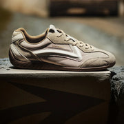Beige sneaker on a stone surface with a blurred background
