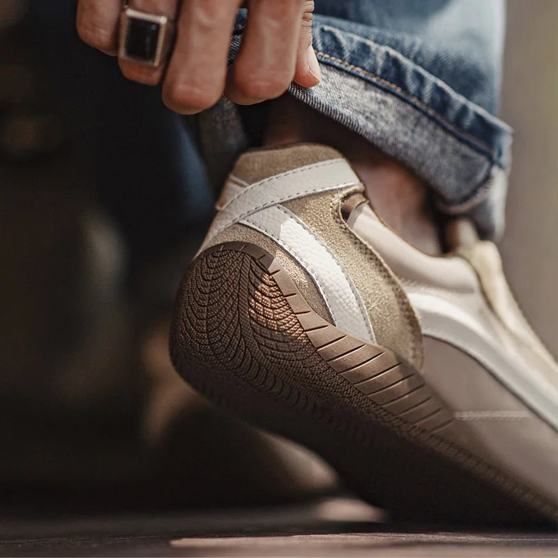 Close-up of a person wearing a brown sneaker with a white sole.