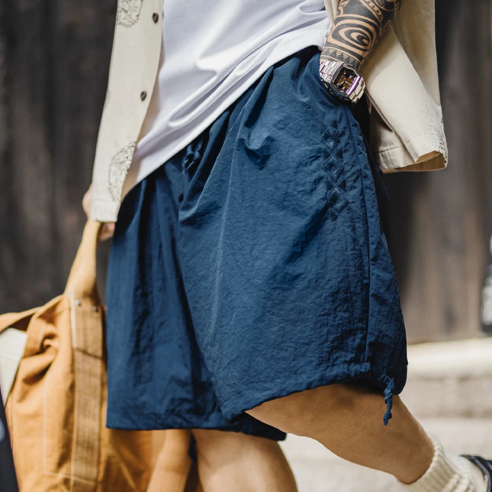 Person wearing blue shorts with a blurred background