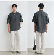 Person wearing a dark gray shirt and light-colored pants, shown from front and back views.