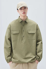 Person wearing a green textured shirt and beige cap on a white background