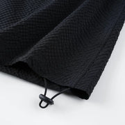 Black textured drawstring bag on a white background