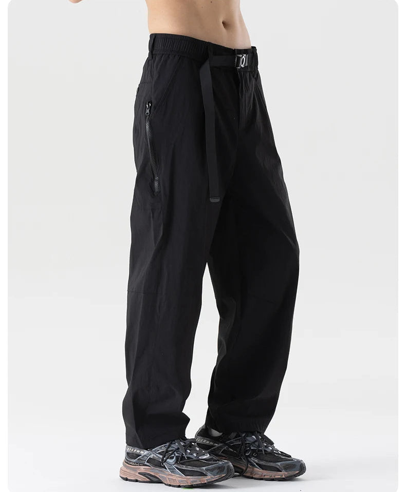 Black pants worn by a person on a white background