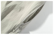 Close-up of a zipper on a light-colored fabric with text overlay.