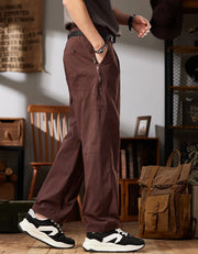 Person wearing brown workwear casual pants with a rustic interior setting.