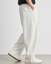 Person wearing white pants with a plain background