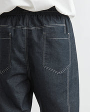 Dark gray pants with white stitching on a white background