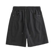 Black shorts with drawstring on a white background