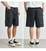 Two views of a person wearing black denim shorts on a white background