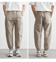 Beige pants worn by a person on a plain background