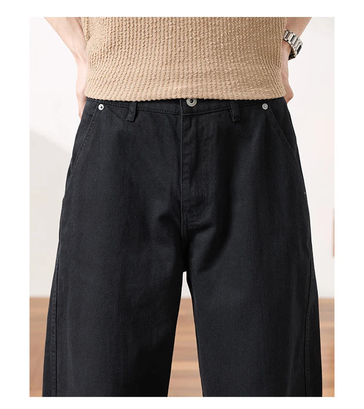 Close-up of a person wearing black wide-leg pants and a beige knit top
