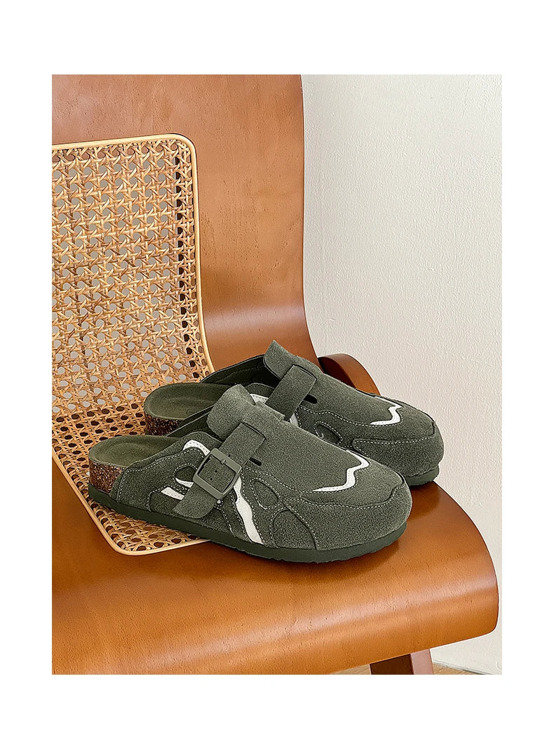 Green slippers with velcro straps on a brown chair