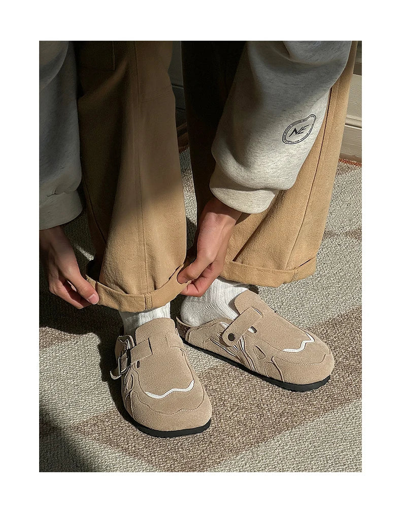 Person wearing beige shoes with a buckle on a carpeted floor