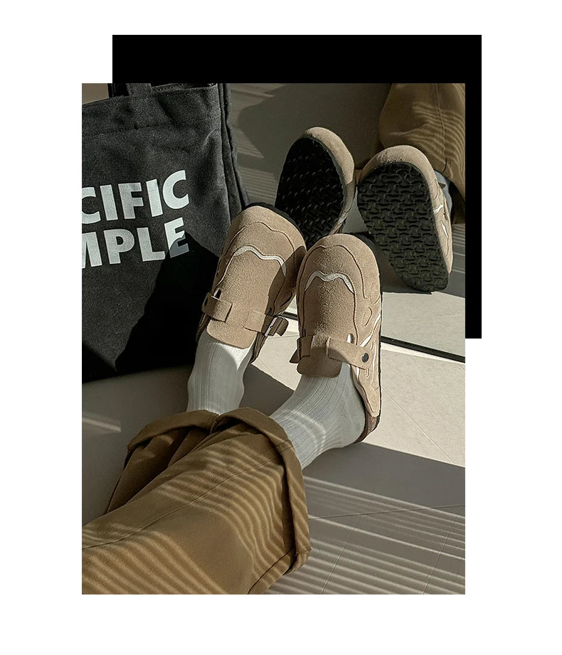 Beige loafers worn with light gray socks on a neutral background