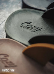 Close-up of Cozy brand leather products on a textured surface