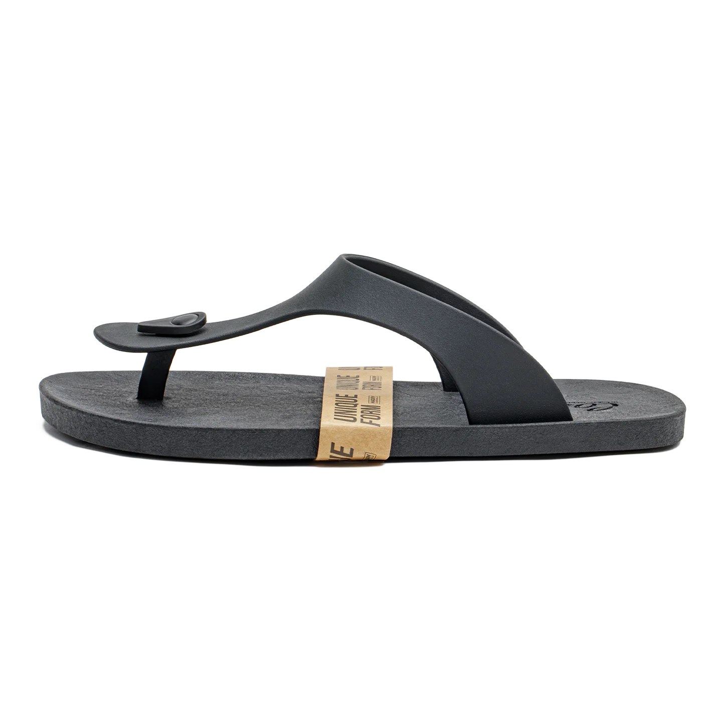 A single black thong sandal with a small black heart detail on the strap, shown from the side against a plain white background. A tan paper band is wrapped around the midsole.